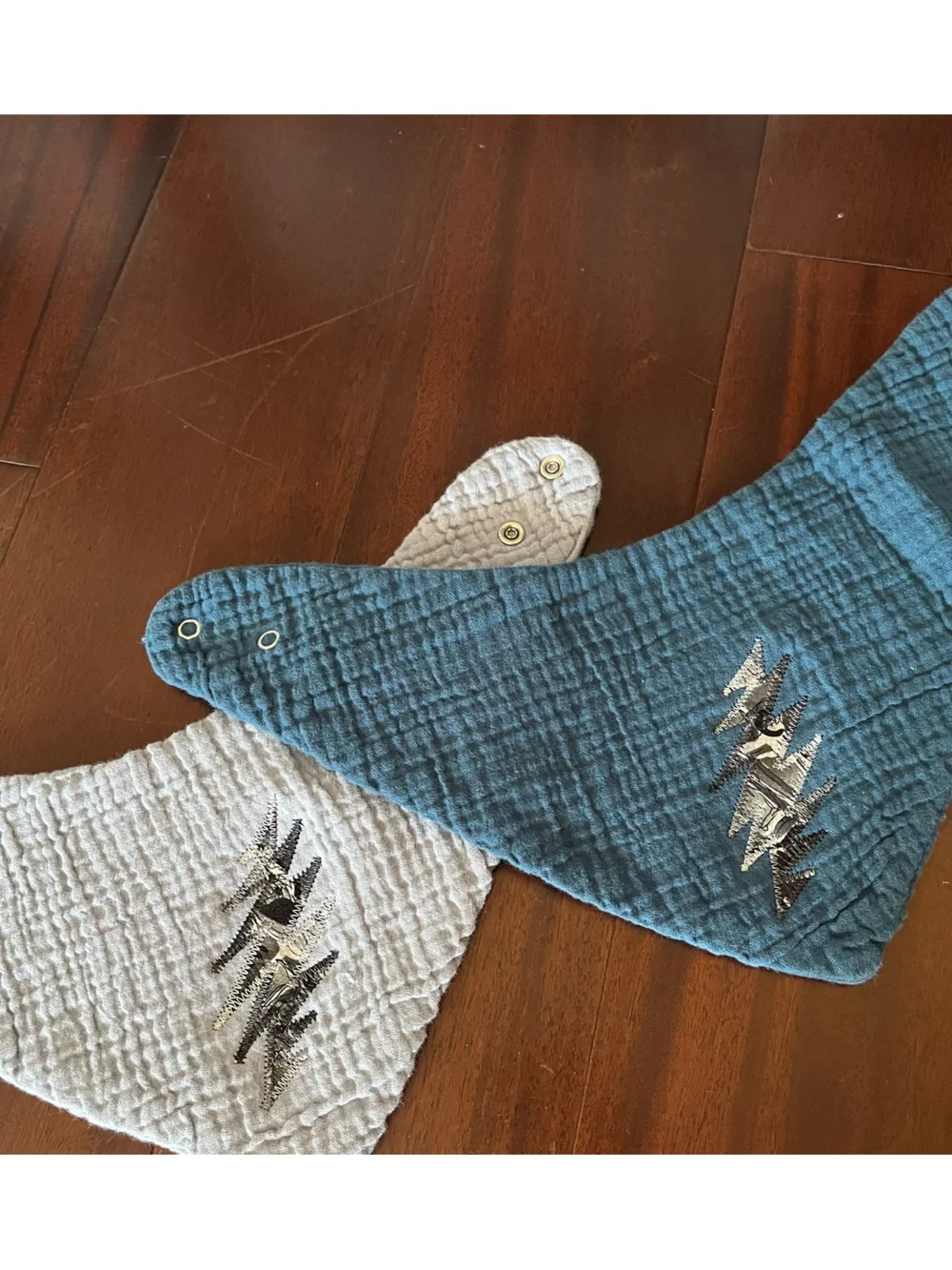 Baby bibs with stealie bolt patches made from Jerry’s silk art ties GRATEFUL